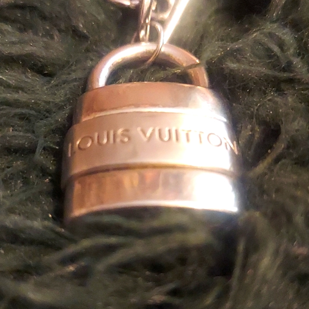Vintage distressed Louis Vuitton iconic lock necklace. Chain is 18” inches long